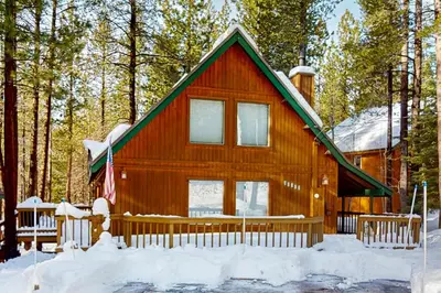 a cabin in the woods with snow on the ground at The Hideaway in Meadow Lake Park