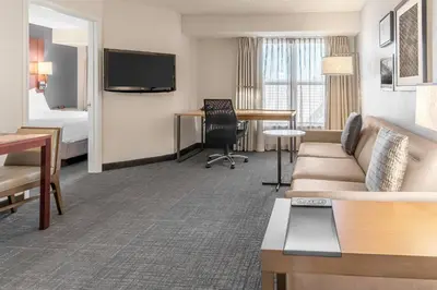 a hotel room with a couch and a bed at Residence Inn Sacramento Rancho Cordova in Rancho Cordova