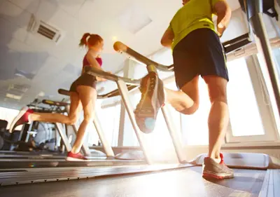 a man and woman running on a treadmill in a gym at Circus Circus Reno, A Caesars Destination in Reno