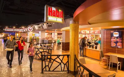 a group of people walking through a shopping mall at Circus Circus Reno, A Caesars Destination in Reno