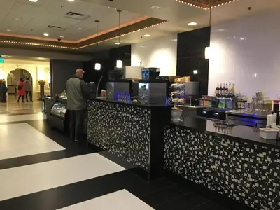 a man standing at a counter in a restaurant at Circus Circus Reno, A Caesars Destination in Reno