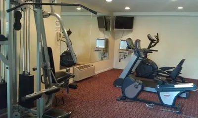 a gym with two exercise bikes in a room at Ramada by Wyndham Fresno North in Fresno