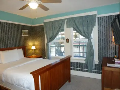 a bedroom with a bed and a window at Americas Best Value Inn Royal Carriage in Jamestown