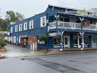 a blue building on the side of a street at Americas Best Value Inn Royal Carriage in Jamestown