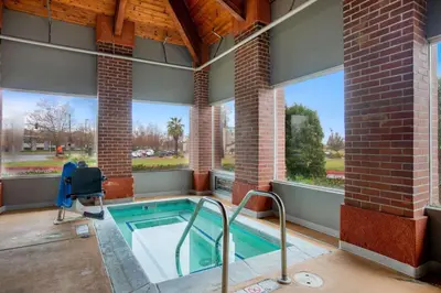 a jacuzzi tub in a building with windows at La Quinta Inn by Wyndham Livermore in Livermore