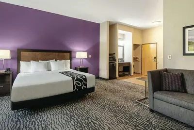 a hotel room with a bed and a couch at La Quinta Inn by Wyndham Livermore in Livermore