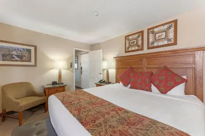a hotel room with a large bed and a chair at Holiday Inn Club Vacations - Tahoe Ridge Resort in Stateline