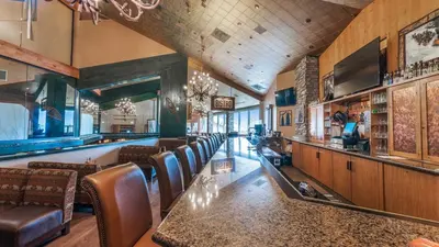 a bar in a restaurant with leather chairs at Holiday Inn Club Vacations - Tahoe Ridge Resort in Stateline