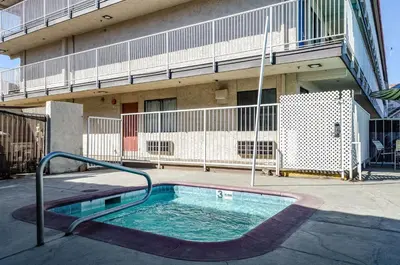 a small swimming pool in front of a building at Motel 6-Fresno, CA - Yosemite Hwy in Pinedale