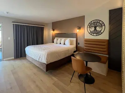 a hotel room with a bed and a table at Lamp Liter Inn Visalia, an Ascend Collection Hotel in Visalia