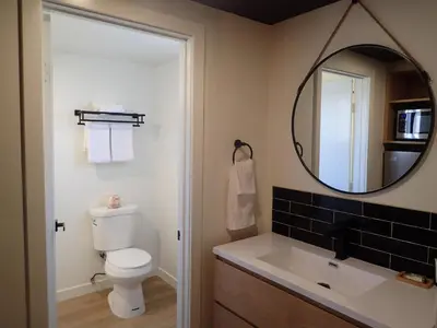 a bathroom with a toilet and a mirror at Lamp Liter Inn Visalia, an Ascend Collection Hotel in Visalia