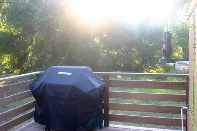 a tent sitting on top of a wooden fence at Little Red Caboose in Oakhurst