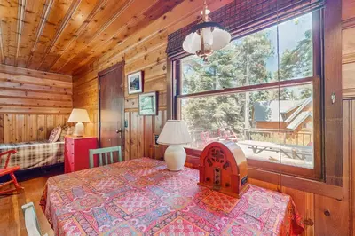 a bedroom with a bed and a large window at The Cherry Leaf Lodge & Retreat on Fallen Leaf Lake in Fallen Leaf