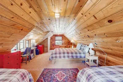a room with two beds in a log cabin at The Cherry Leaf Lodge & Retreat on Fallen Leaf Lake in Fallen Leaf