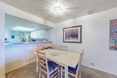 a kitchen and dining room with a table and chairs at The Bridges 102 in Mammoth Lakes