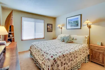 a small bedroom with a bed and a window at Wildflower 55 in Mammoth Lakes