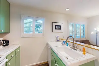 a kitchen with a sink and two windows at La Vista Blanc 39 in Mammoth Lakes