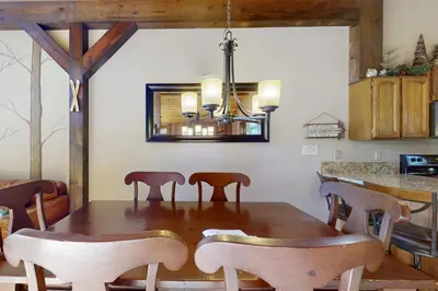 a dining room with a wooden table and chairs at Woodlands 34 in Mammoth Lakes
