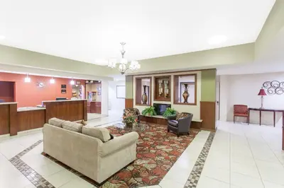 a lobby with a couch and a table at Ramada by Wyndham Fresno Northwest in Fresno