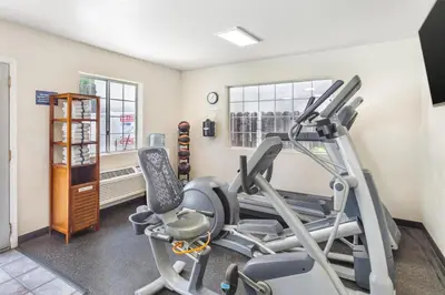 a gym with a treadmill and two tread machines at Best Western Luxury Inn in Tracy