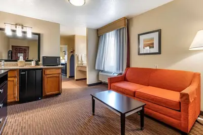 a living room with a couch and a table at Best Western Luxury Inn in Tracy