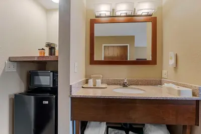 a bathroom with a sink and a mirror at Comfort Inn Lathrop Stockton Airport in Lathrop