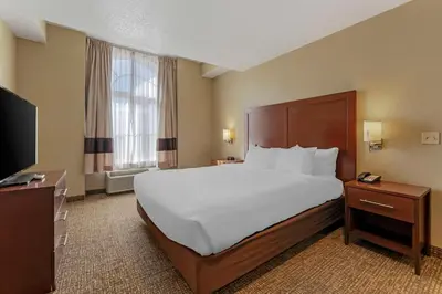 a hotel room with a large bed and a television at Comfort Inn Lathrop Stockton Airport in Lathrop