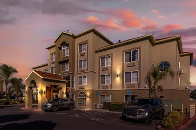 a large building with cars parked in front of it at Comfort Inn Lathrop Stockton Airport in Lathrop