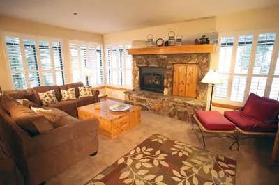 a living room with a couch and a fireplace at Silver Bear # 20 in Mammoth Lakes