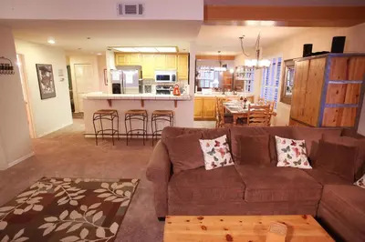 a living room with a couch and a kitchen at Silver Bear # 20 in Mammoth Lakes