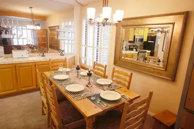 a dining room with a table and a kitchen at Silver Bear # 20 in Mammoth Lakes