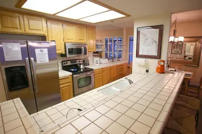 a kitchen with a sink and a refrigerator at Silver Bear # 20 in Mammoth Lakes