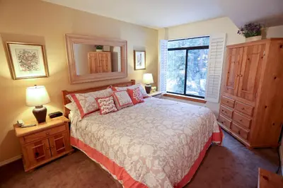a bedroom with a large bed and a window at Silver Bear # 20 in Mammoth Lakes