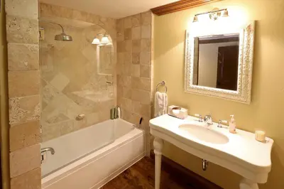a bathroom with a sink and a tub and a mirror at Silver Bear # 36 in Mammoth Lakes