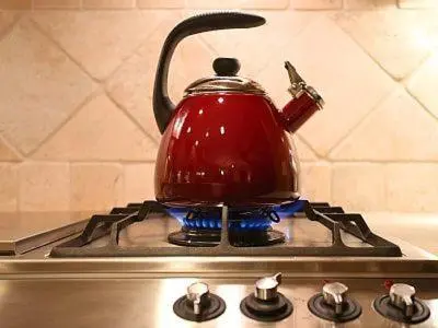 a red tea kettle sitting on top of a stove at Silver Bear # 36 in Mammoth Lakes