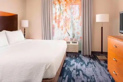 a hotel room with a large bed and a window at Fairfield Inn & Suites by Marriott Selma Kingsburg in Kingsburg