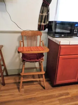 a wooden chair sitting in a kitchen next to a stove at NEW CHARMING 2 BEDROOMS UNIT CLOSE TO EVERYTHING in Oakhurst