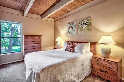 a bedroom with a bed with two lamps and a window at South Lake Tahoe Resort - Steps to Beach & Close to Heavenly in South Lake Tahoe