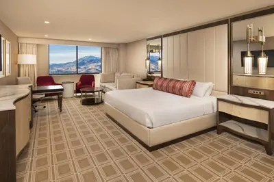 a hotel room with a bed and a desk at Grand Sierra Resort and Casino in Reno