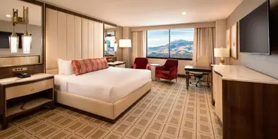 a hotel room with a bed and a desk at Grand Sierra Resort and Casino in Reno