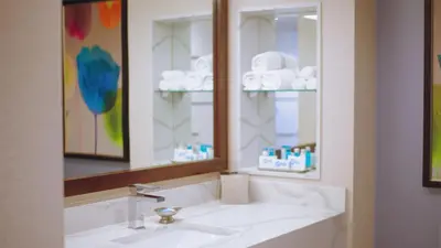 a bathroom with a sink and a mirror and towels at Grand Sierra Resort and Casino in Reno