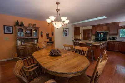 a large kitchen with a wooden table and chairs at Bruin's Den in Wawona