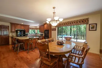 a kitchen with a table and chairs and a dining room at Bruin's Den in Wawona