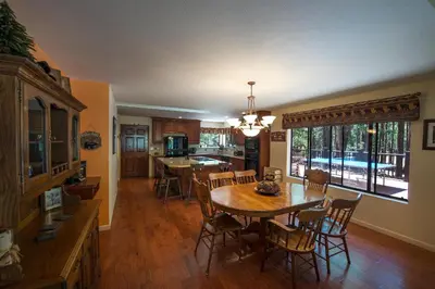 a kitchen and dining room with a table and chairs at Bruin's Den in Wawona