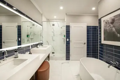a bathroom with two sinks and a large mirror at J Resort in Reno