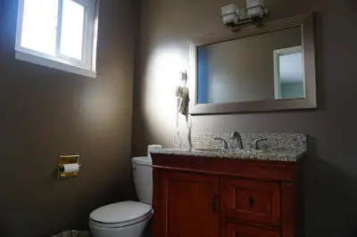 a bathroom with a toilet and a sink and a mirror at A&A Lake Tahoe Inn in South Lake Tahoe