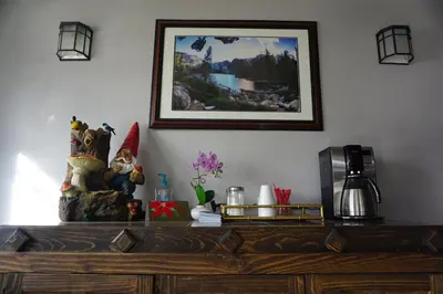 a wooden dresser with a picture on the wall at A&A Lake Tahoe Inn in South Lake Tahoe