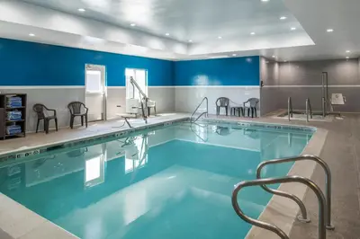 a large swimming pool with chairs around it at Fairfield Inn and Suites by Marriott Elk Grove in Elk Grove
