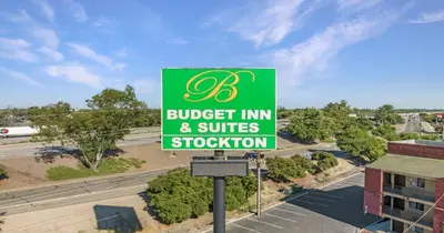 a green sign for a budget inn and suites robbery at Budget Inn and Suites Stockton Yosemite in Stockton