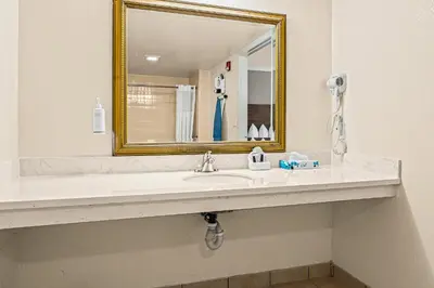 a bathroom with a sink and a mirror at Heritage Inn Express Roseville in Roseville